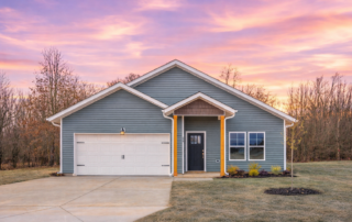 AspenExteriorSunset Aspen floor plan by Maplewood Homes with a front-entry garage, covered porch, enhanced landscaping, and sunset sky