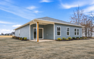 AspenExteriorbackyard Aspen floor plan by Maplewood Homes featuring a covered back patio, spacious backyard, and single-story exterior design