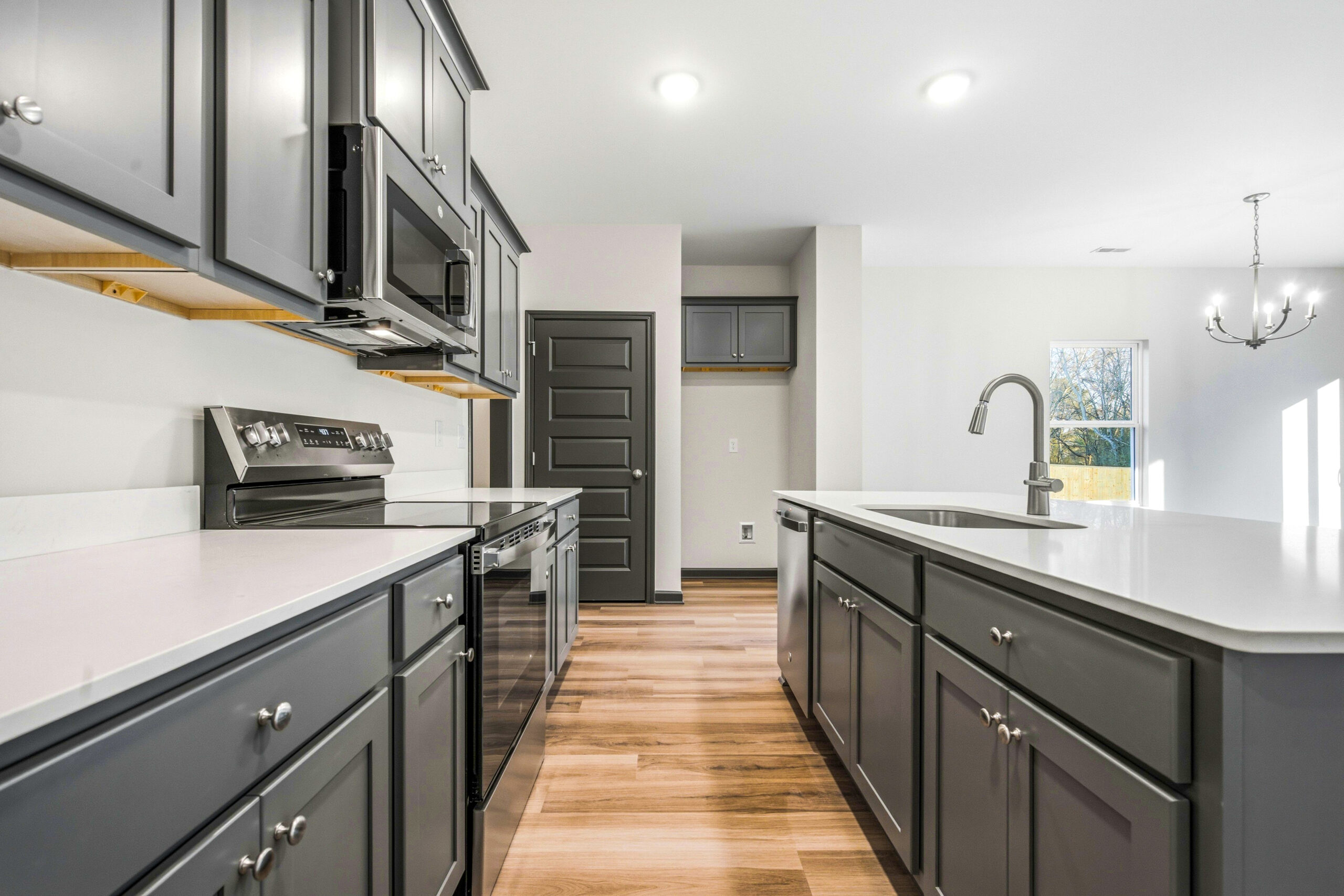 BirchKitchen The Birch floor plan kitchen by Maplewood Homes with modern gray cabinets and open concept design