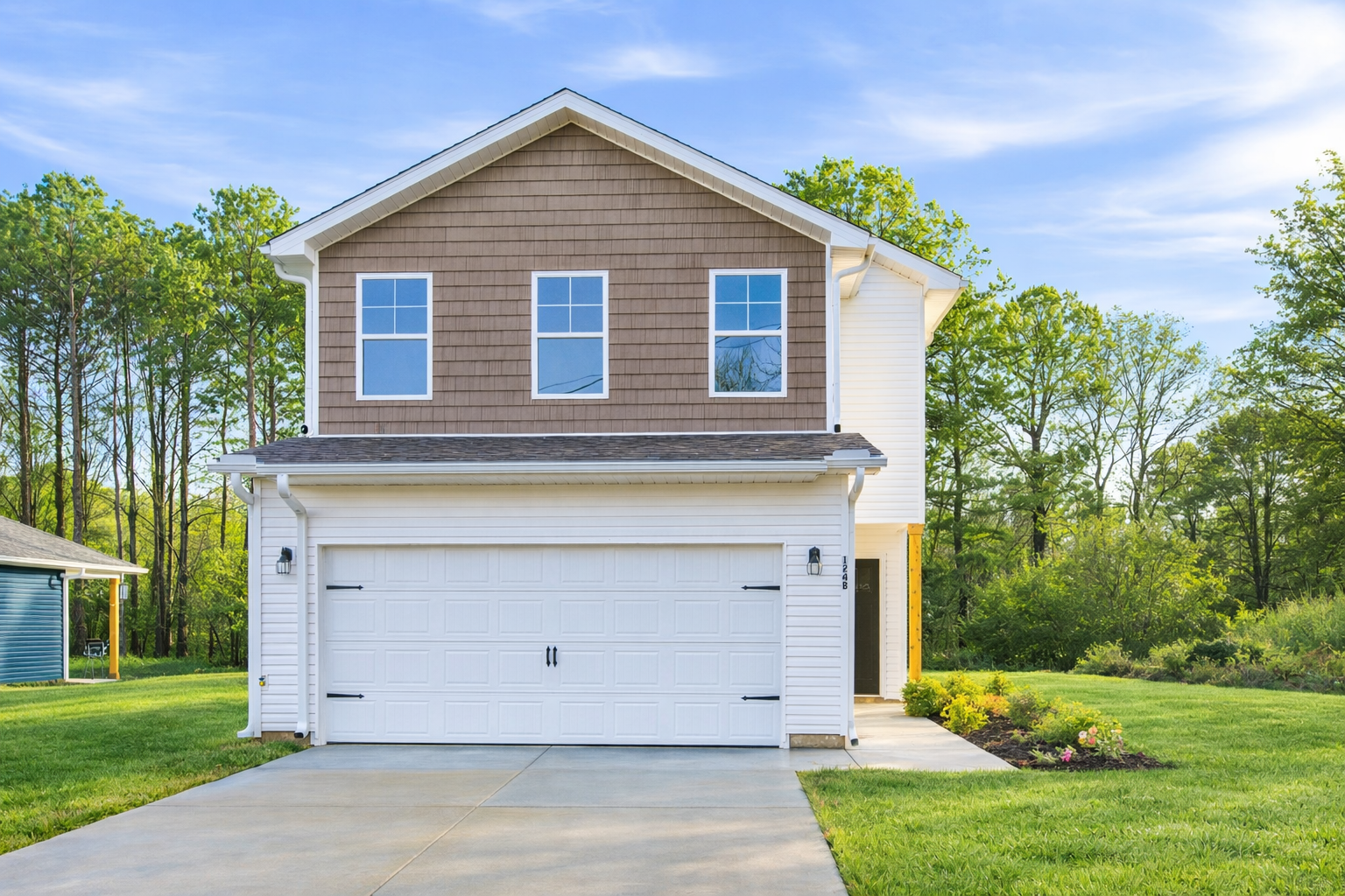Birchexterior1 The Birch floor plan by Maplewood Homes two-story new construction home with front-entry garage and landscaped yard