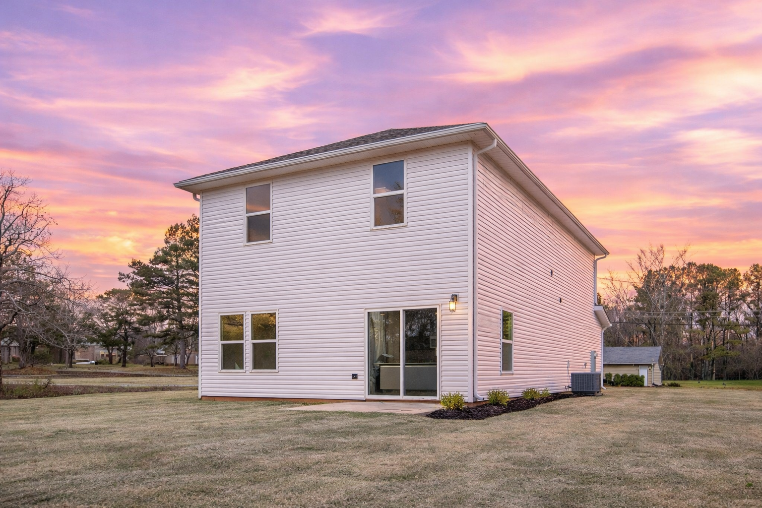 Birchexteriorbackyard The Birch floor plan backyard by Maplewood Homes with patio and sunset exterior