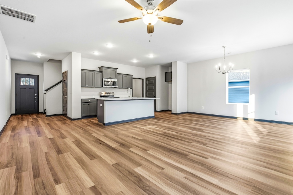 Dexter-17 The Birch floor plan open concept living room and kitchen by Maplewood Homes with large island and spacious layout