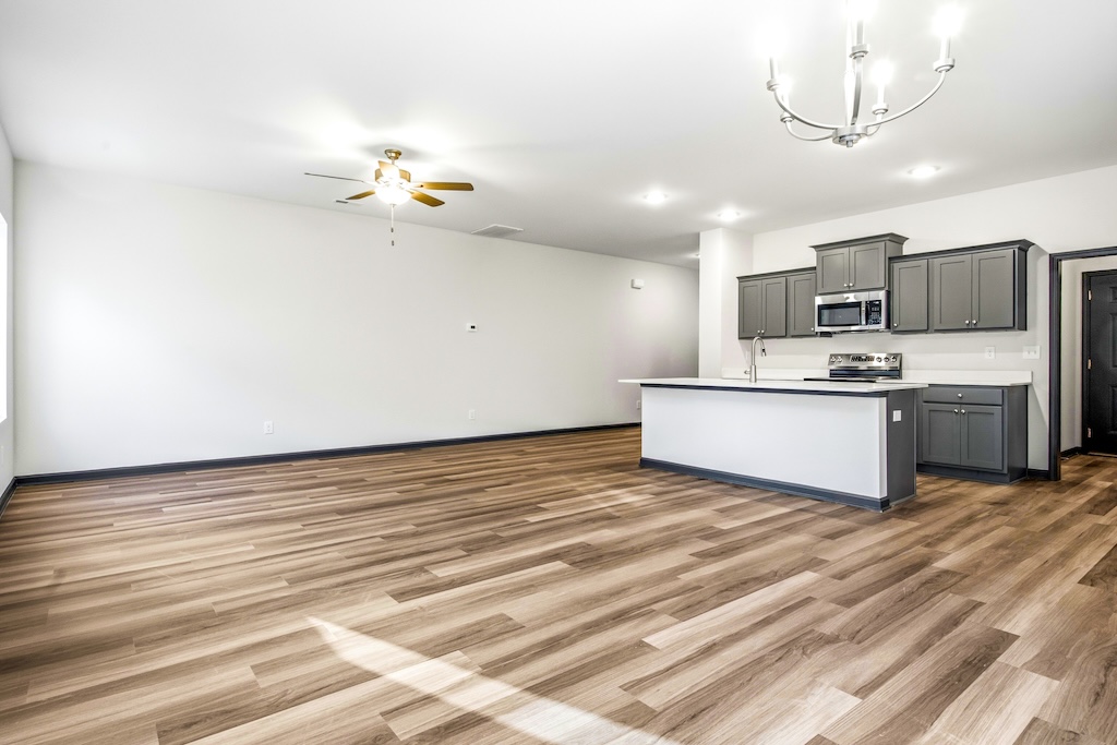 Dexter-20 The Birch floor plan open living area by Maplewood Homes with kitchen island and spacious family room