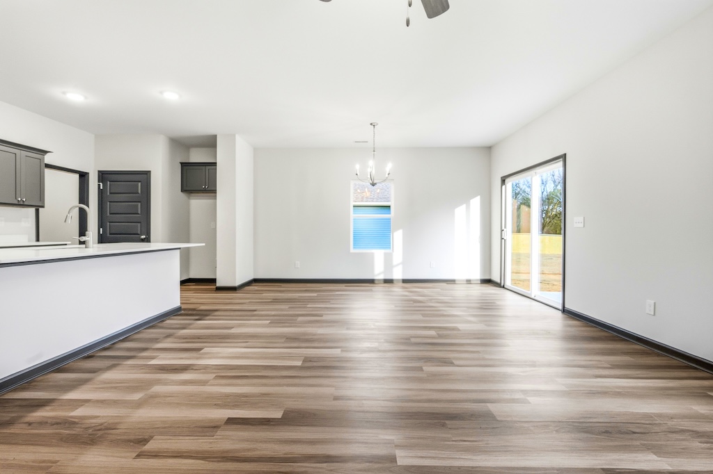 Dexter-26 The Birch floor plan dining area and kitchen by Maplewood Homes with sliding glass door and open layout