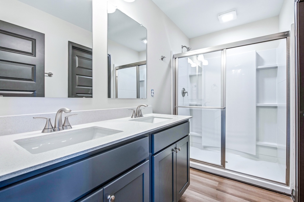 Dexter-3 The Birch floor plan primary bathroom by Maplewood Homes with double vanity and walk-in shower