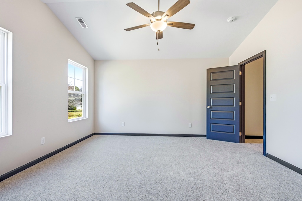 Dexter-5 The Birch floor plan secondary bedroom by Maplewood Homes with carpet flooring and natural light