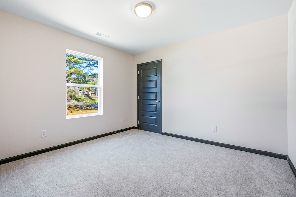 Dexter-6 The Birch floor plan additional bedroom by Maplewood Homes with modern finishes and neutral colors