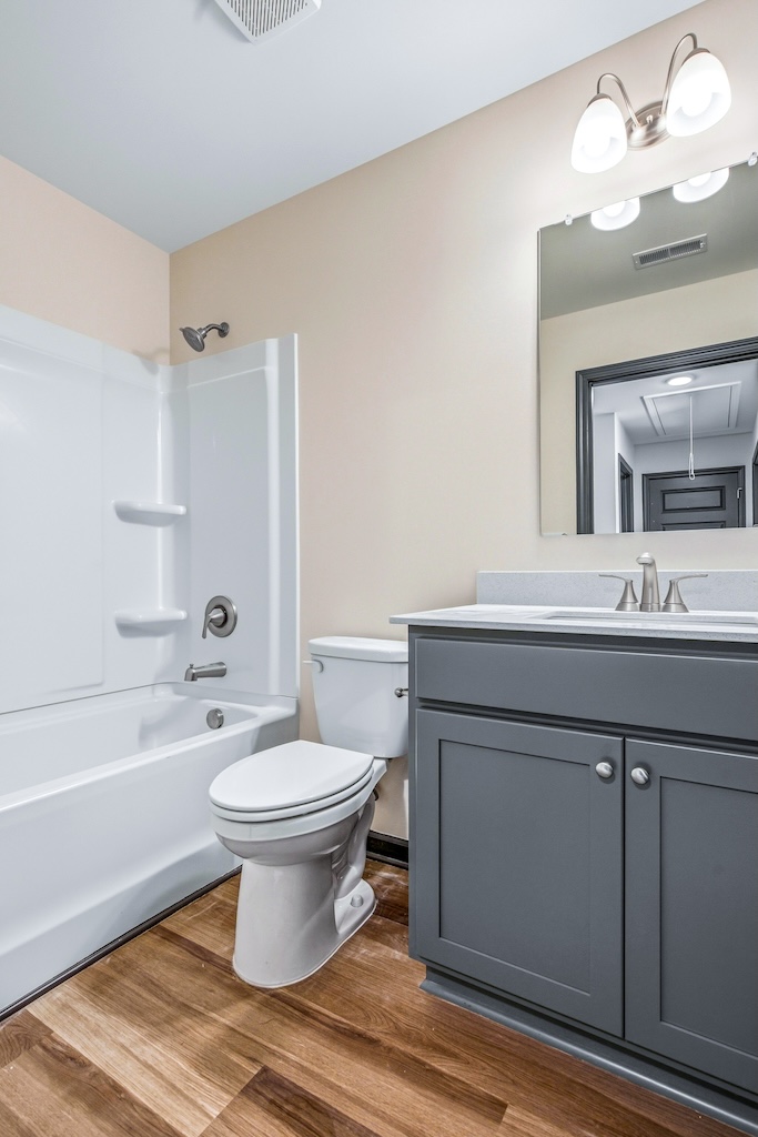 Dexter-9 The Birch floor plan hall bathroom by Maplewood Homes featuring vanity and shower tub combination