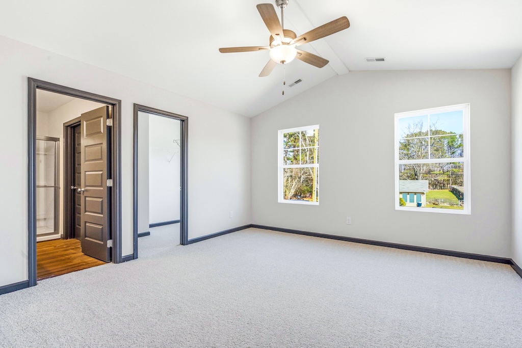 Dexter The Birch floor plan primary bedroom by Maplewood Homes featuring large windows and spacious layout