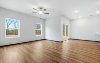 Tercel-12 Aspen floor plan living room by Maplewood Homes with ceiling fan, large windows, and open layout