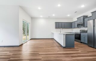 Tercel-13 Aspen floor plan dining area and kitchen by Maplewood Homes with sliding glass door and open design