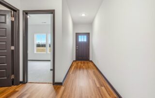 Tercel-19 Aspen floor plan interior hallway by Maplewood Homes with luxury vinyl plank flooring and modern trim details