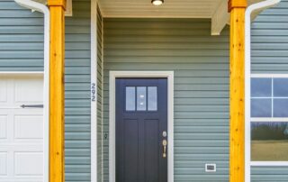 Tercel-4 Aspen floor plan front entry by Maplewood Homes with covered porch, wood columns, and modern front door