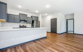 Tercel-8 Aspen floor plan open concept kitchen and living room by Maplewood Homes with large breakfast bar